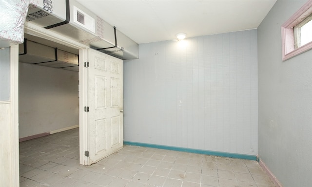 basement featuring light tile patterned floors