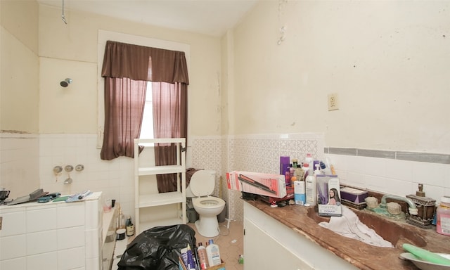 bathroom with toilet, decorative backsplash, tile patterned flooring, and tile walls