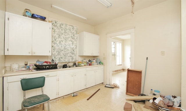 kitchen featuring sink and white cabinets