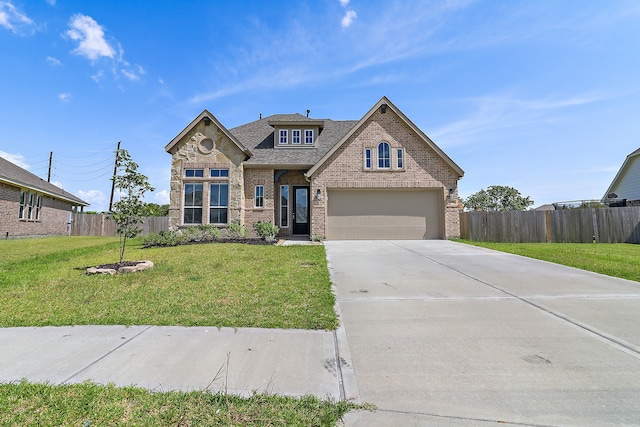 view of front of property with a garage and a front lawn