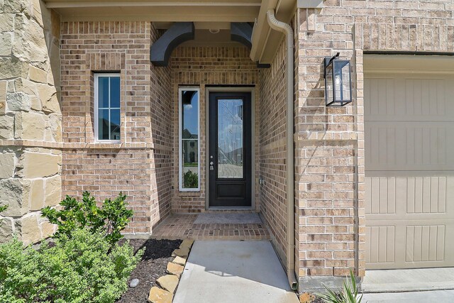 doorway to property with a garage