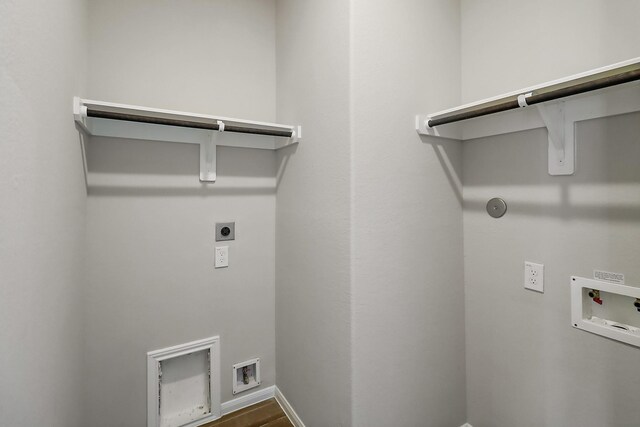 clothes washing area featuring electric dryer hookup, hardwood / wood-style floors, and washer hookup