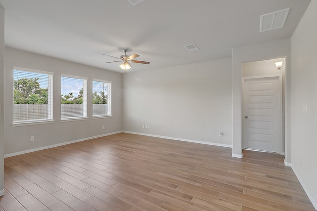 spare room featuring light hardwood / wood-style flooring and ceiling fan