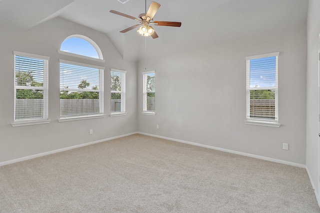 carpeted spare room with ceiling fan and high vaulted ceiling