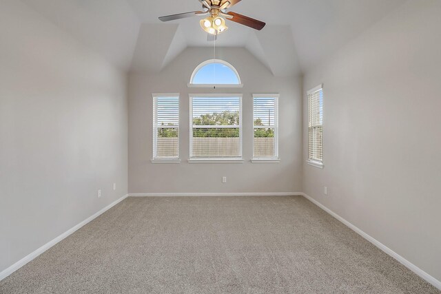 spare room featuring carpet flooring, ceiling fan, and vaulted ceiling