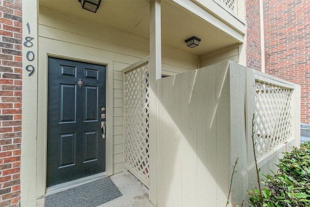 property entrance with brick siding