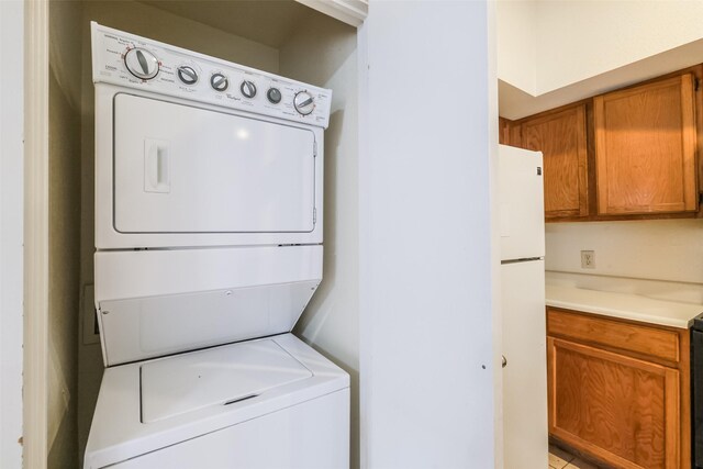 washroom featuring stacked washer / dryer