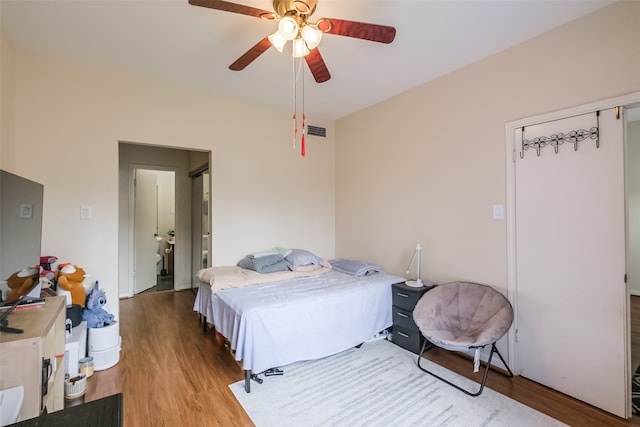 bedroom with wood-type flooring and ceiling fan