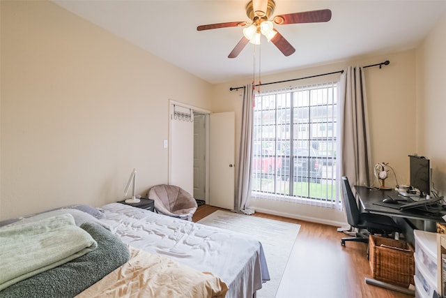 bedroom with light hardwood / wood-style flooring and ceiling fan