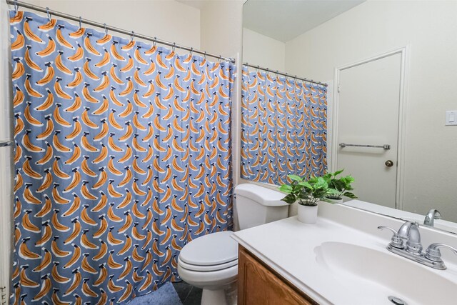 bathroom with vanity, toilet, and tile patterned flooring