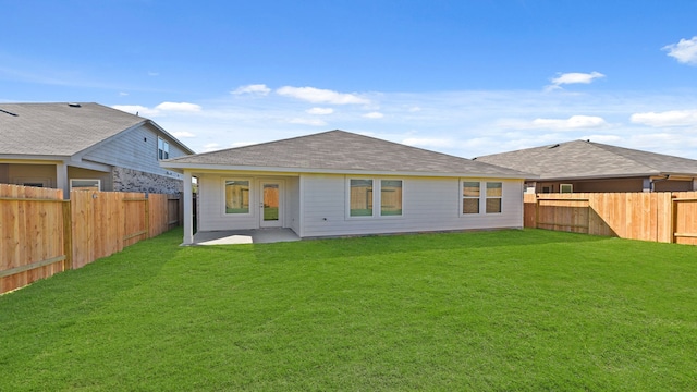 rear view of house with a lawn and a patio area