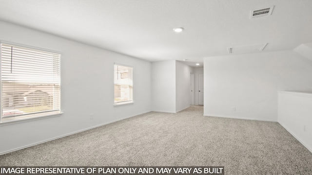 unfurnished room featuring light carpet