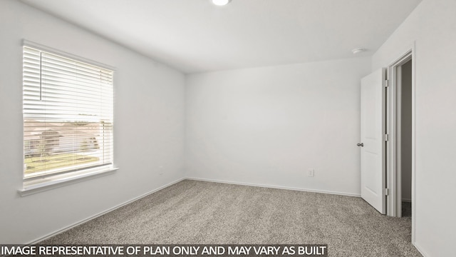 carpeted spare room featuring plenty of natural light