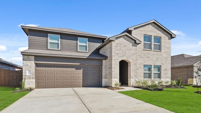 view of front of home featuring a front yard and a garage