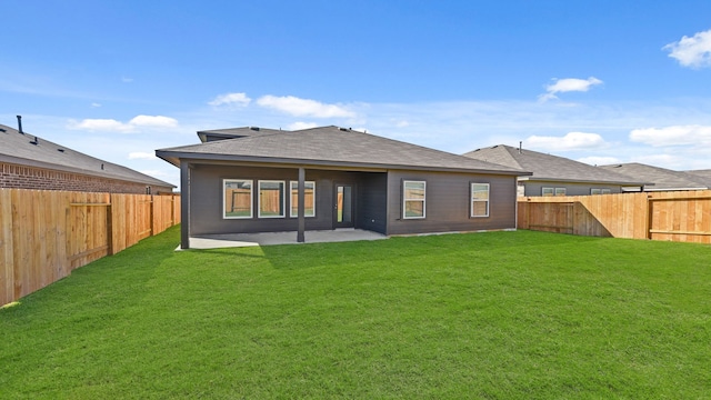 rear view of property with a patio and a lawn