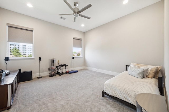 living area featuring light colored carpet and ceiling fan