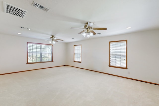 carpeted spare room with ceiling fan