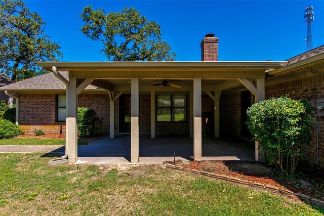 exterior space with a patio area, a yard, and ceiling fan