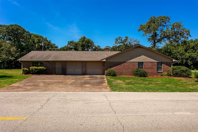 ranch-style house featuring a garage and a front yard