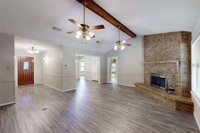 unfurnished living room with a fireplace, ceiling fan, wood-type flooring, and a wealth of natural light