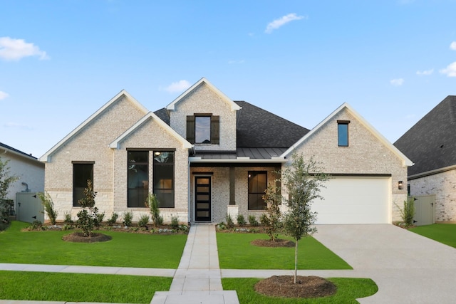 view of front of home featuring a garage and a front yard