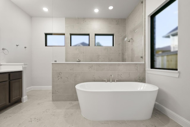 bathroom with vanity, separate shower and tub, and a healthy amount of sunlight