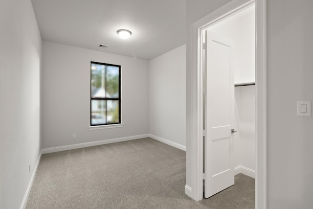 unfurnished room featuring light colored carpet