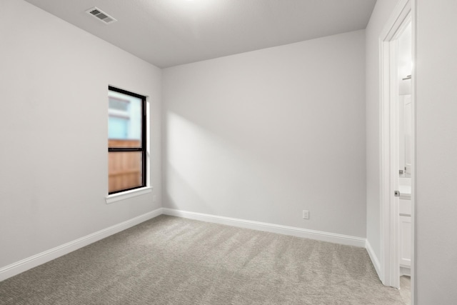 unfurnished room with light colored carpet