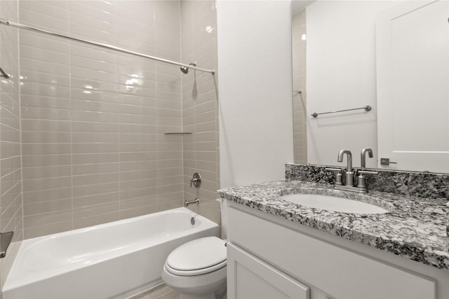 full bathroom with vanity, toilet, and tiled shower / bath