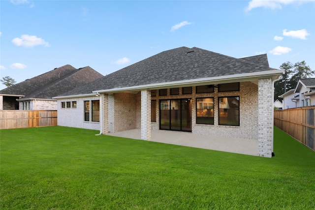 back of house featuring a lawn