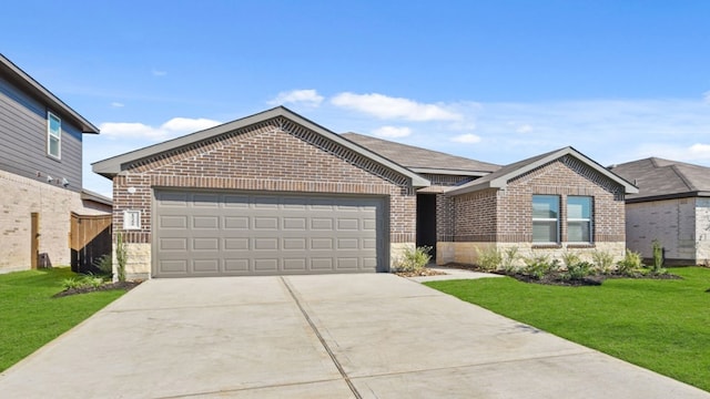 view of front of property with a garage and a front lawn