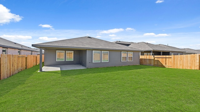 rear view of property with a patio and a lawn