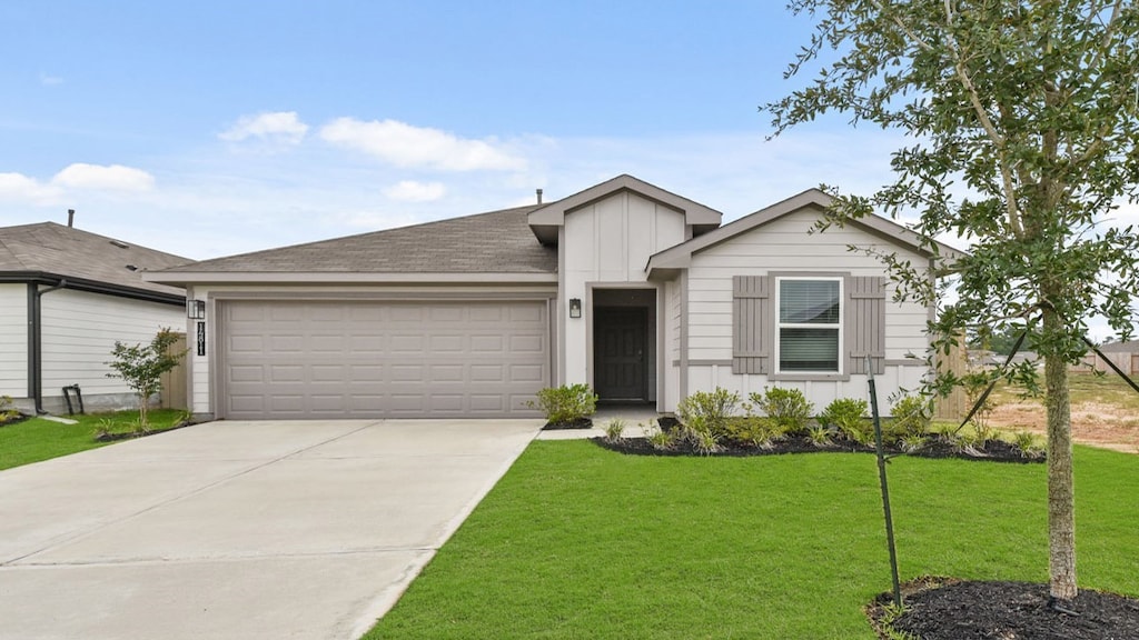 view of front of house with a front yard and a garage