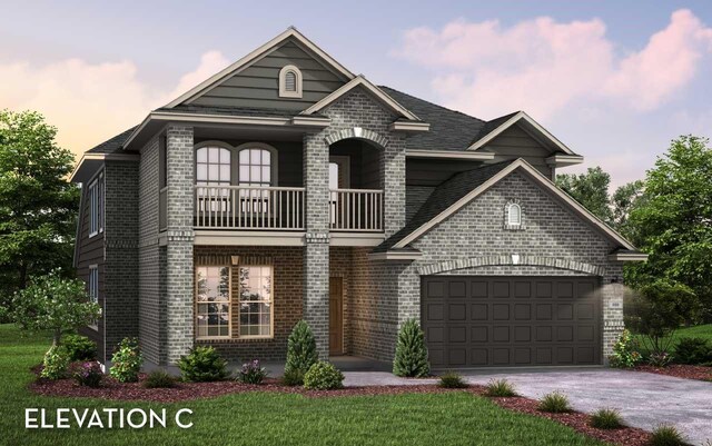 view of front facade with a balcony, a garage, and a yard