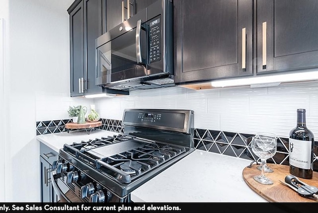 kitchen featuring black gas range oven and backsplash