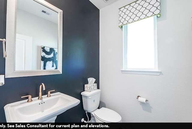 bathroom featuring toilet and sink