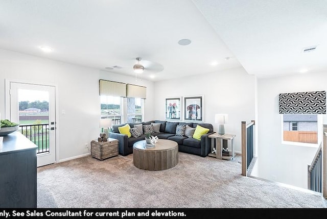 carpeted living room featuring ceiling fan