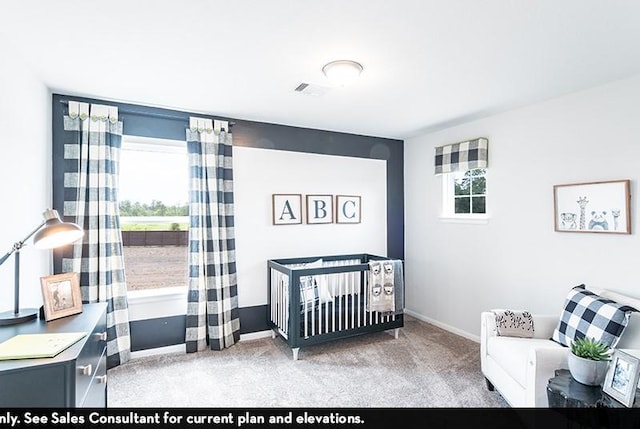 carpeted bedroom with a nursery area