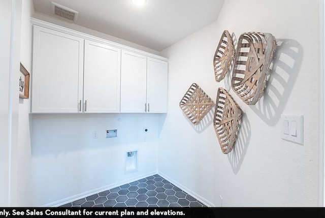 washroom featuring electric dryer hookup, washer hookup, and cabinets