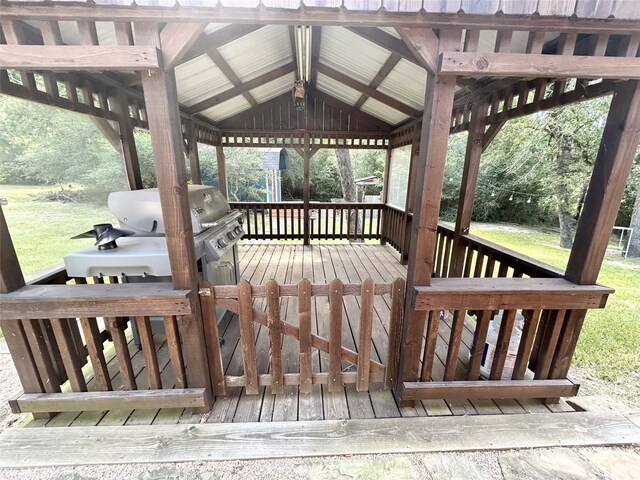 wooden deck with area for grilling and a gazebo