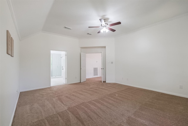 carpeted empty room with crown molding, vaulted ceiling, and ceiling fan