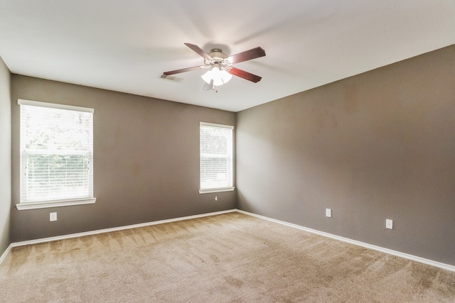 empty room with carpet floors and ceiling fan