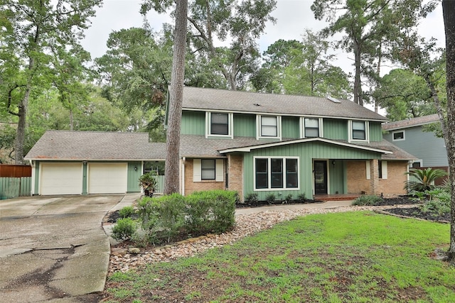 view of front of house with a garage and a front lawn