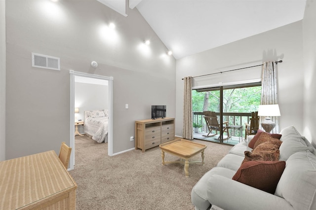 carpeted living room with beam ceiling and high vaulted ceiling