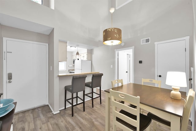 dining space with light hardwood / wood-style flooring