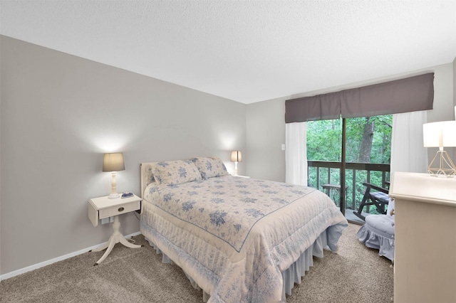 carpeted bedroom with access to exterior and a textured ceiling