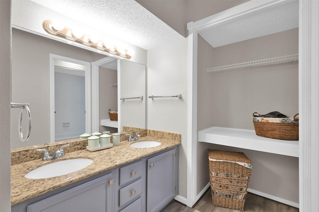 bathroom featuring vanity and a textured ceiling