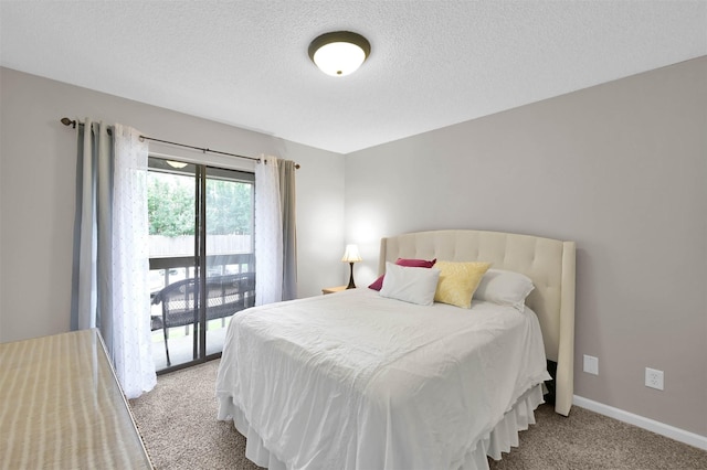 bedroom featuring light colored carpet, a textured ceiling, and access to outside