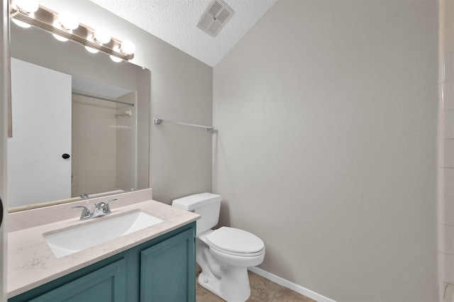 bathroom with lofted ceiling, vanity, a textured ceiling, toilet, and walk in shower