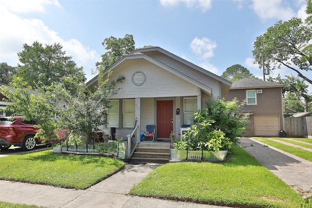 view of front of home featuring a garage and a front lawn